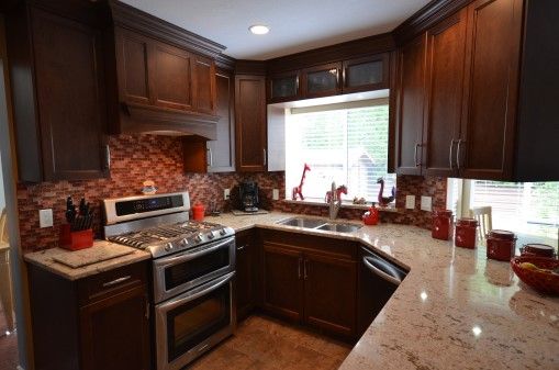 U-Shaped kitchen with red tile backsplash.